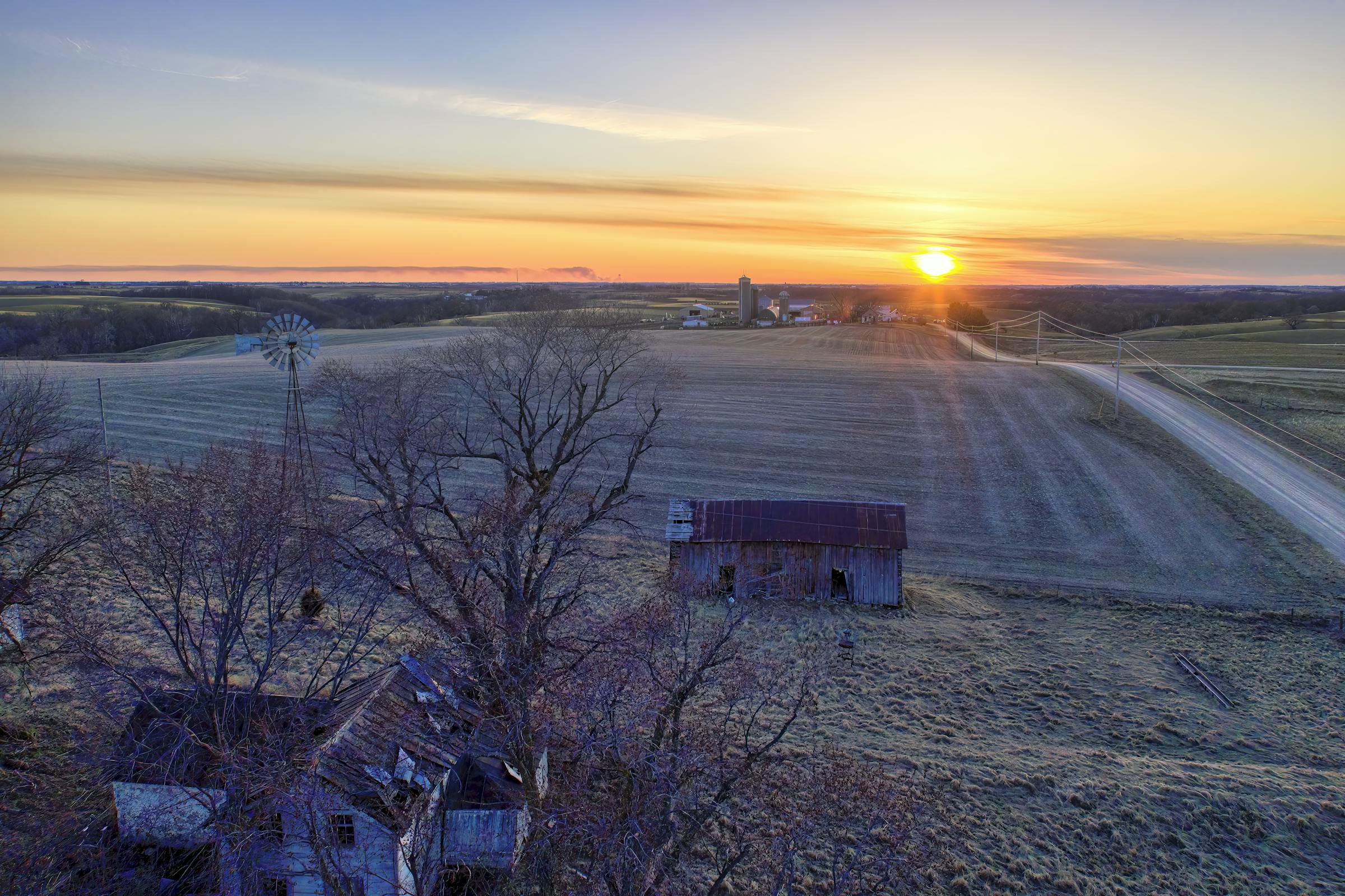 Aerial view of American farmland and a homestead at sunset