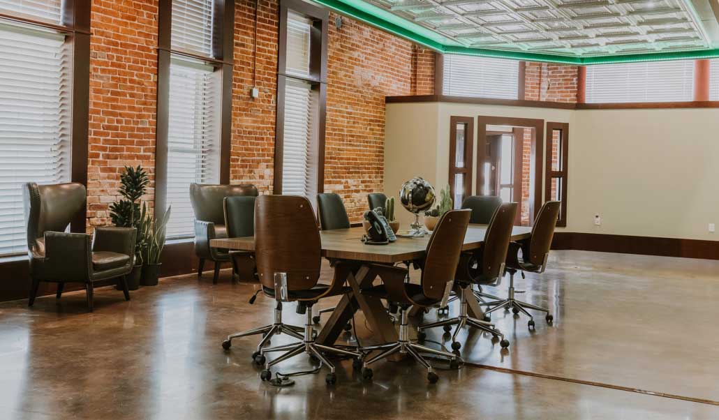 Heritage Land & Minerals conference room with exposed brick walls and a long wood table at the Venus, Texas headquarters